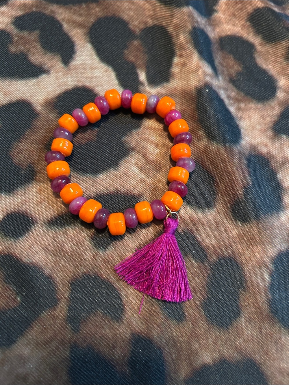 Hand Crafted Orange and Purple Beaded Bracelet with Pink Tassel